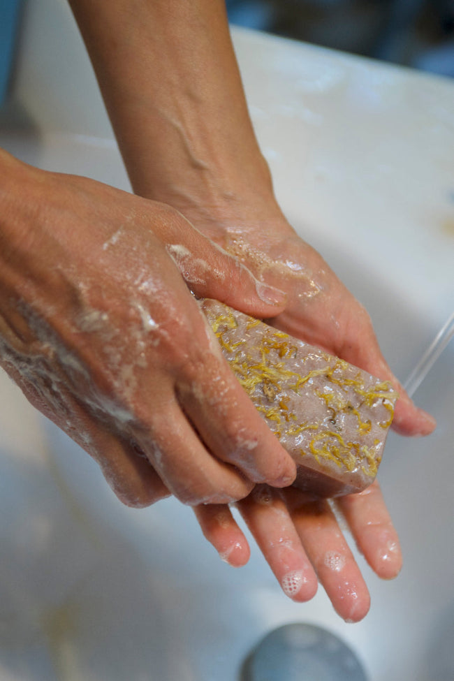 washing hands with calendula soap
