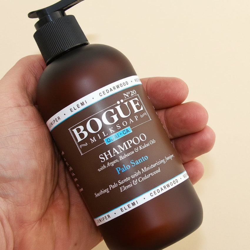 Palo Santo Organic Shampoo in hand 8oz for side
