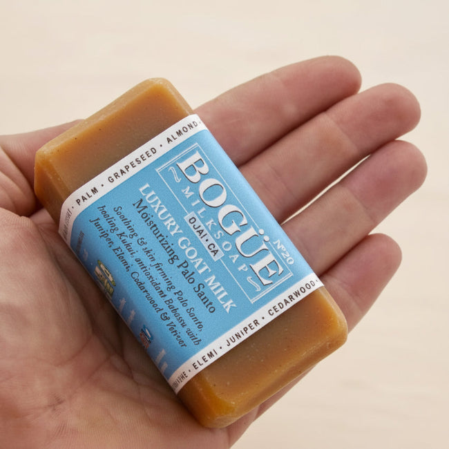 bar of organic palo santo soap in hand for size