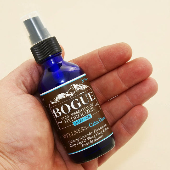 Chamomile Essential Oil Hydrolyzer Spray in hand 2oz bottle for size