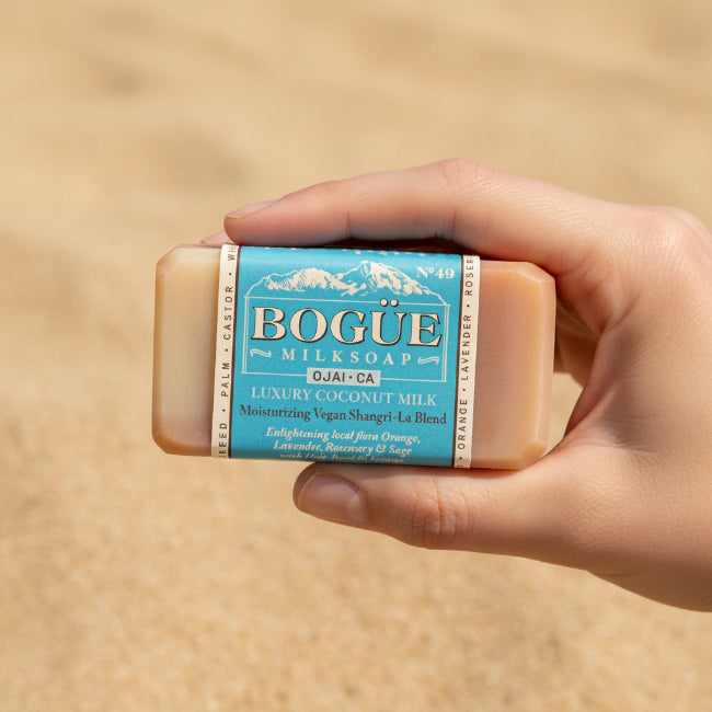 vegan coconut milk soap with essential oils in hand for size