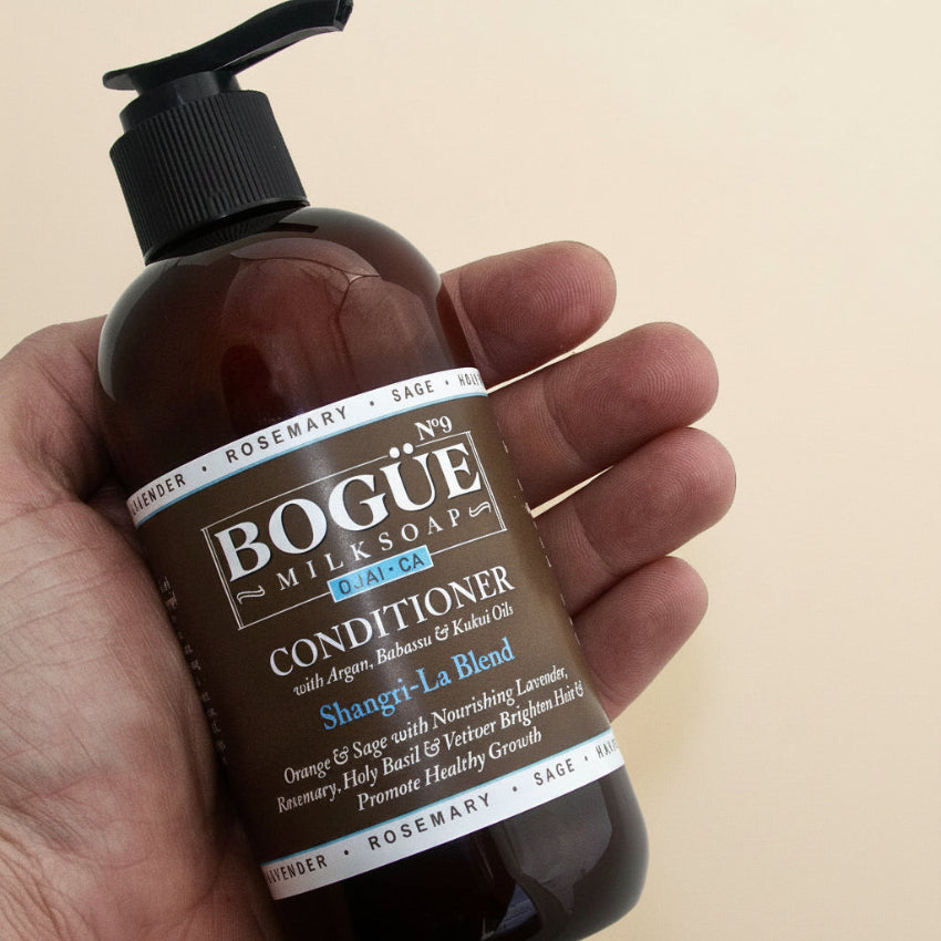 Lavender Organic Conditioner in hand 8oz for size