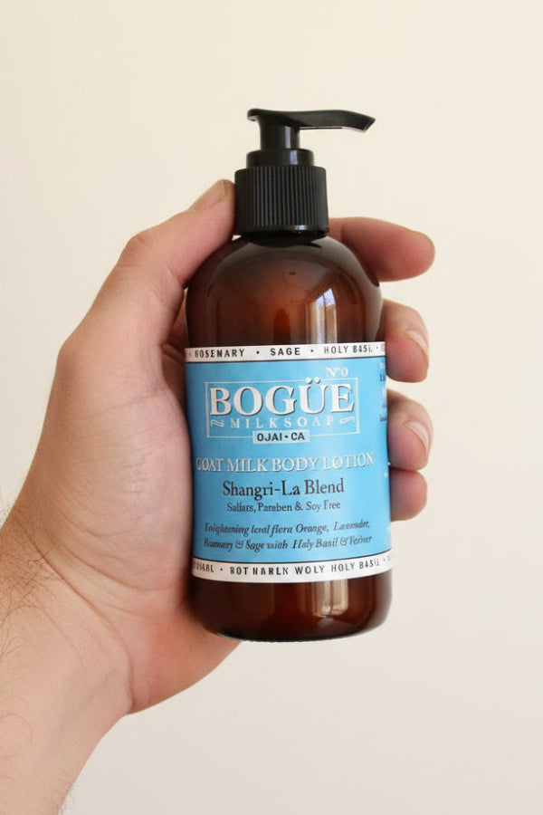 goat milk lotion bottle of Bogue in hand