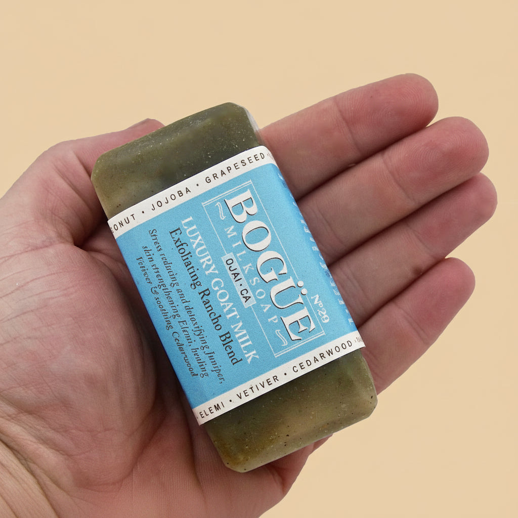 Goat milk soap with kaolin clay and exfoliants in hand for size