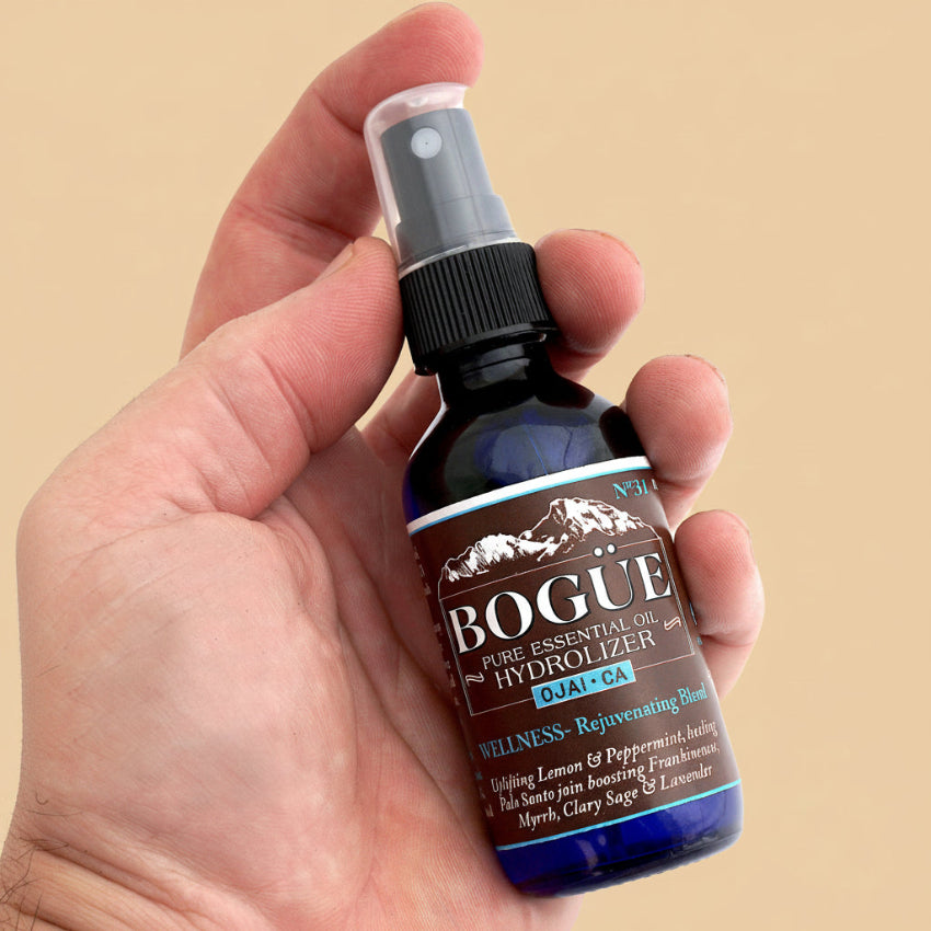 Rejuvenating Essential Oil Hydrolizer Spray in hand 2oz for size