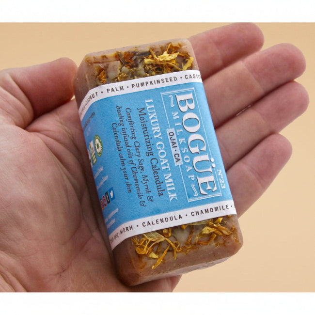 holding a chamomile moisturizing calendula topped soap in hand for size
